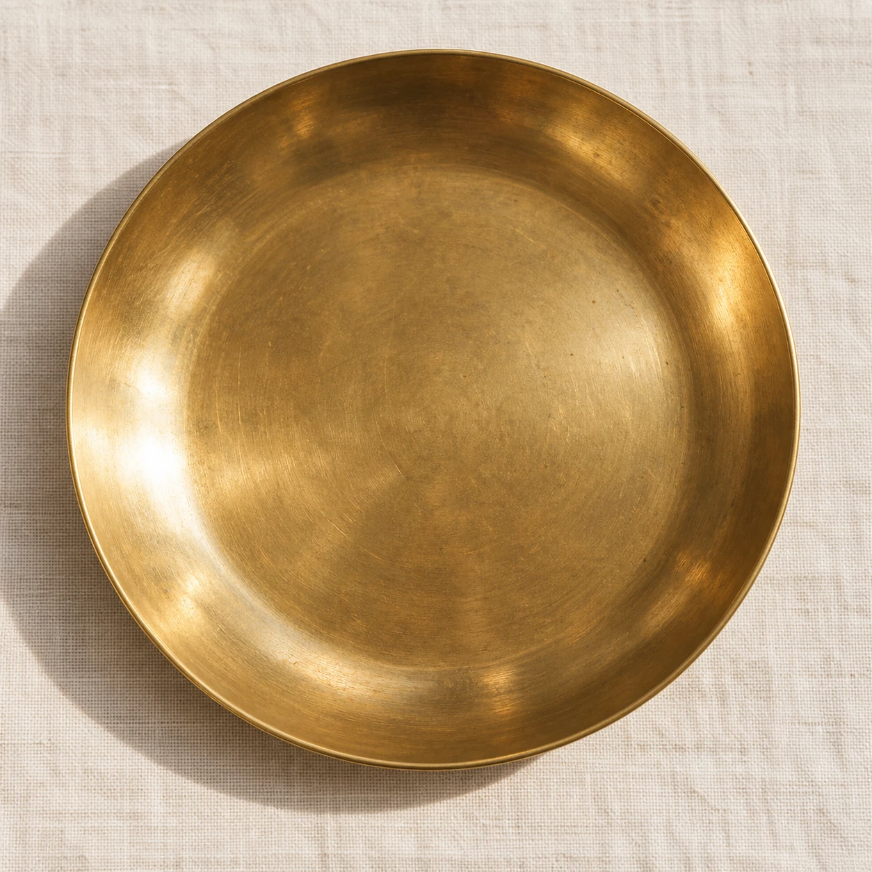 Polished brass with a warm glow, softly reflective.