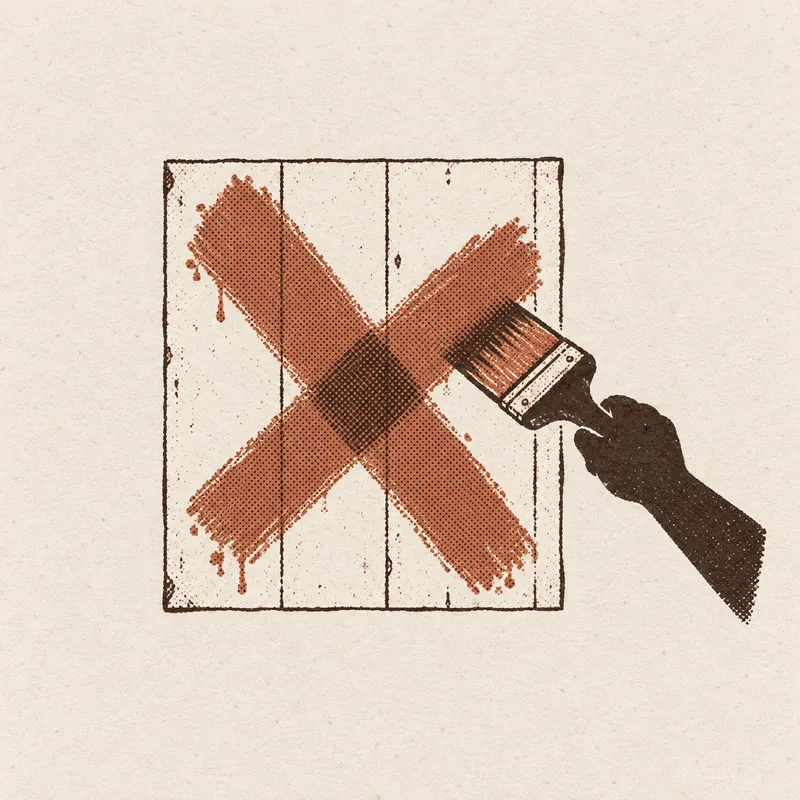 A hand painting a large X in one brushstroke of orange paint across a plain wood panel.