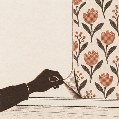 A hand peeling back the bottom corner of a floral peel-and-stick sheet to show the plain wall underneath, tulips and leaves printed on the sheet above.