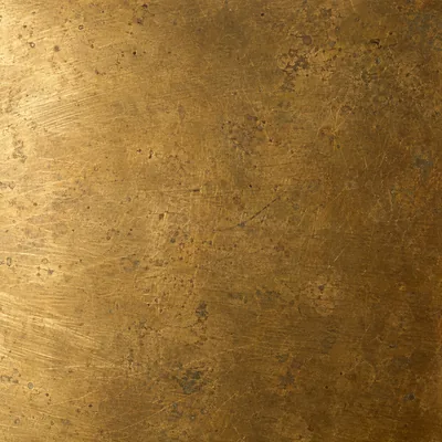 New aged brass up close: an even warm metal surface with a faint brushed grain.