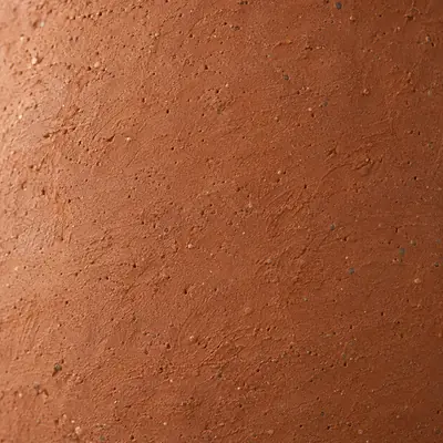 New unglazed terracotta up close: a dry even clay surface with faint throwing lines.
